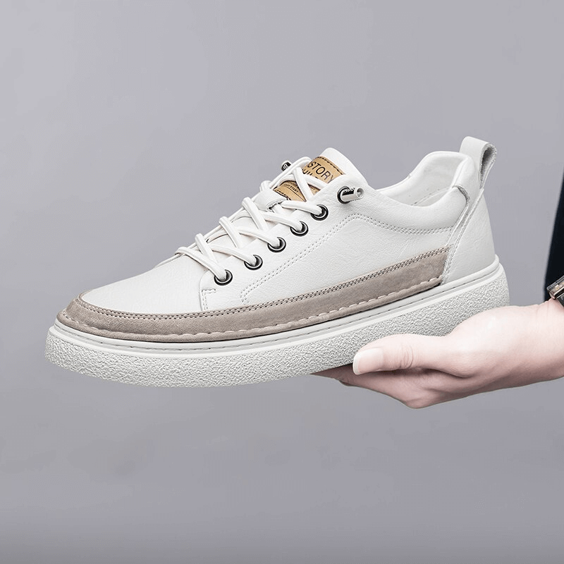 Stylish white leather men's sneakers with lace-up design and rubber sole for breathability and comfort.